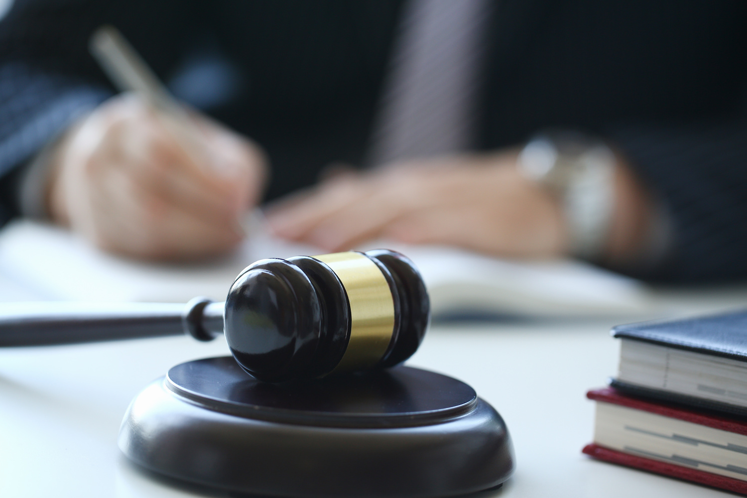 gavel with notes being written in the background